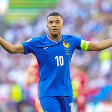Kylian Mbappé on a soccer field.