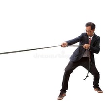 A person pulling forcefully on a rope.