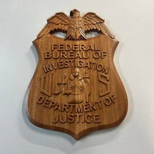 A federal agent’s badge representing a government agent.
