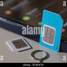 A SIM card shown next to a smartphone.