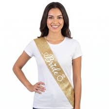 A bachelorette party participant wearing a “Bride to Be” sash.