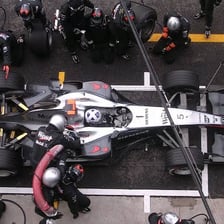 A racing crew refueling a car during a pit stop