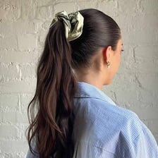 Hair gathered into a ponytail and secured with a scrunchie