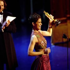 An actor giving an acceptance speech while an awards-show orchestra plays