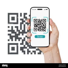 A black-and-white QR code being scanned by a smartphone