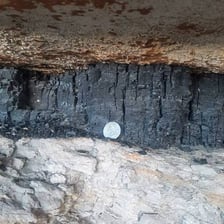 A visible seam of coal in a mine wall