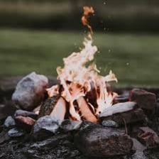 A small campfire being ignited again