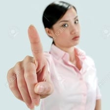 A person giving a stern warning with a raised finger