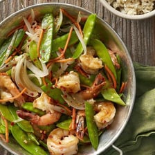 Green pea pods mixed into a vegetable stir-fry.