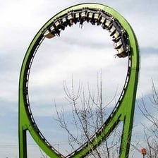 A roller coaster car traveling through a vertical loop