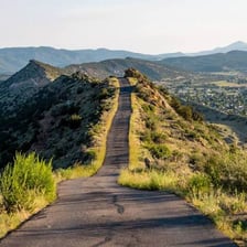 A paved road extending through a landscape.