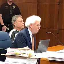 A defendant standing before a judge in a courtroom
