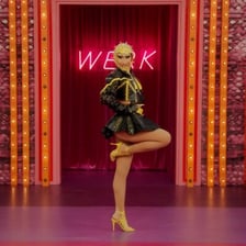 A drag performer strutting down a runway