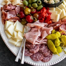 Thin slices of prosciutto arranged on an antipasto platter