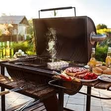 Food cooking on a smoking outdoor barbecue grill