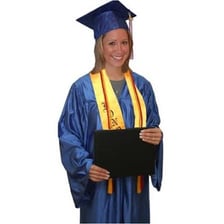 A student wearing a graduation cap and holding a diploma