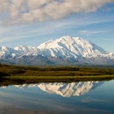 Snow-covered Denali rising above the Alaskan landscape.