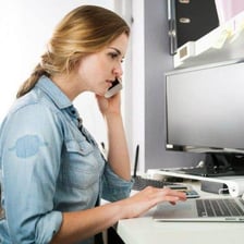 An employee working attentively at a desk.