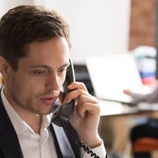 A person responding while holding a phone