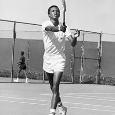 Arthur Ashe playing tennis.