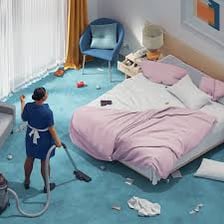 A hotel housekeeper making up a guest room.