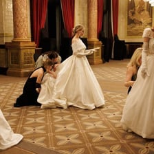 A debutante dressed formally at a ballroom event
