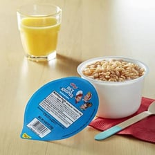 A bowl of puffed rice cereal served with milk.