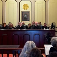 Judges seated together on a courtroom bench