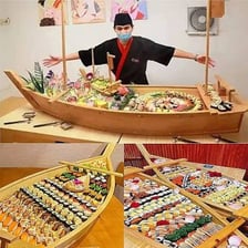 A boat-shaped serving platter filled with assorted sushi.