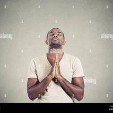 A person praying with clasped hands