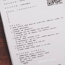 A hand writing information on a sheet of paper