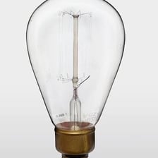 Close-up view of a glowing tungsten filament inside an incandescent light bulb.