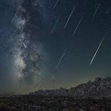 Bright meteors from the Perseid shower streaking across a night sky