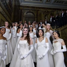Elegantly dressed guests at a high-society gala