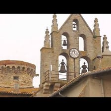 A bell tower with bells ringing