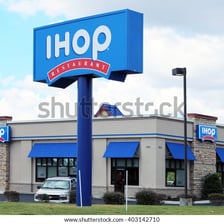 An IHOP restaurant with its recognizable blue-and-red sign.