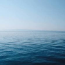 A wide blue sea meeting the horizon.
