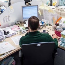 A person actively handling a task at a computer.