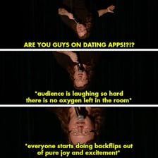 A comedian performing while an audience laughs at a joke.