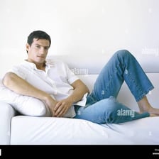 A person relaxing idly on a couch.