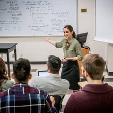 A professor teaching students in a classroom.