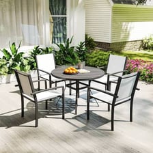 An outdoor patio furnished with a table and chairs.