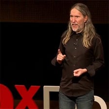 A person confidently reciting words without looking at notes.