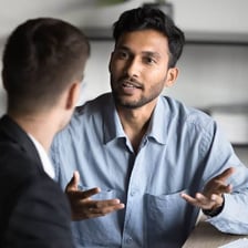 Two people having a conversation in which one hints at an idea