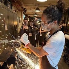 A maker working on a handmade object in a workshop.