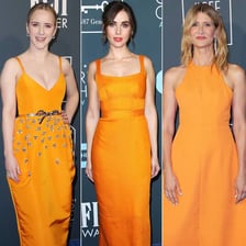 A celebrity wearing a bright orange outfit at a red-carpet event.