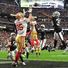 A football player scoring a touchdown during a game.