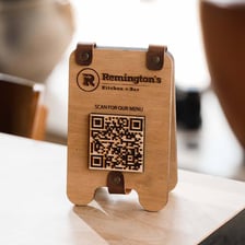 A QR code displayed on a restaurant table for accessing a menu