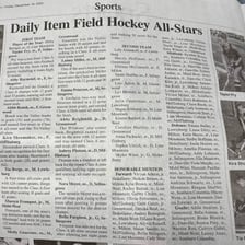 A newspaper article beside a list containing individual line items