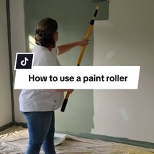 A paint roller applying a single coat of paint to a wall.